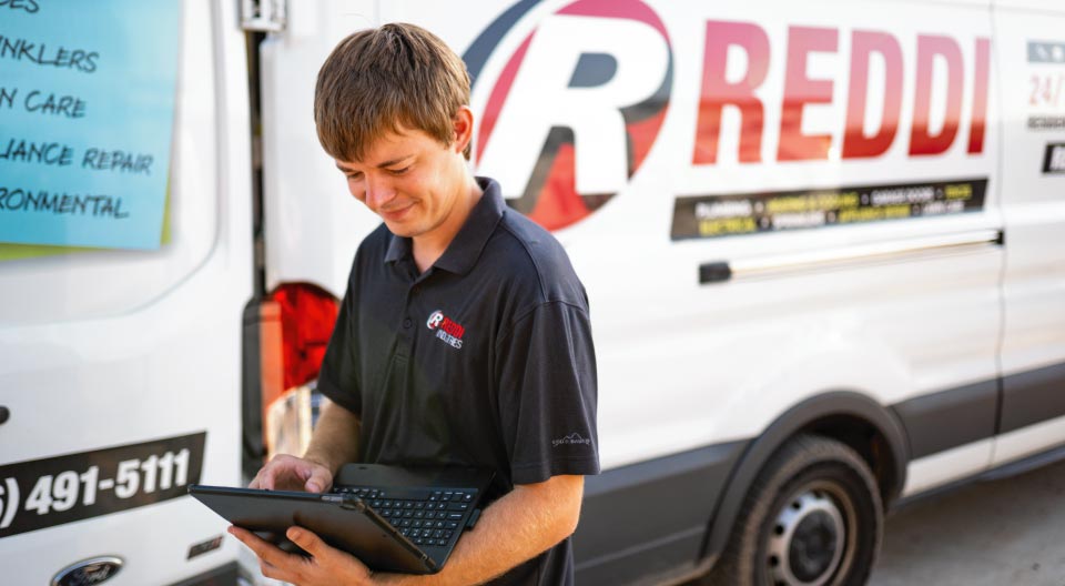 Heating and Cooling Technician using a computer